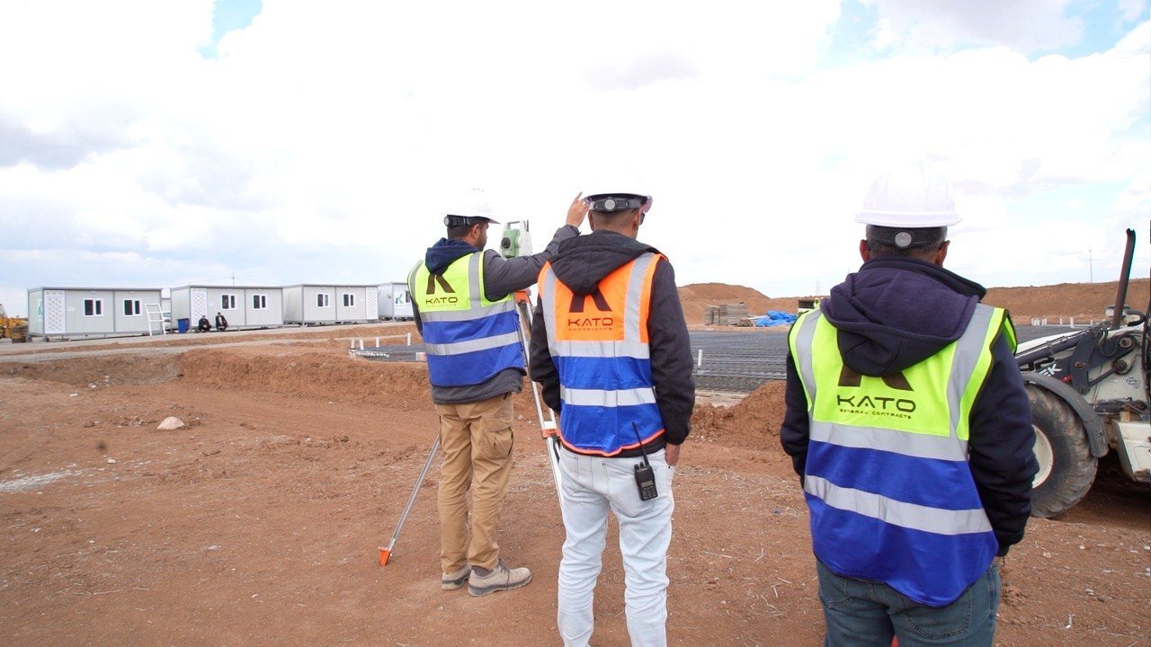 KATO survey team working beside the foundation excavation