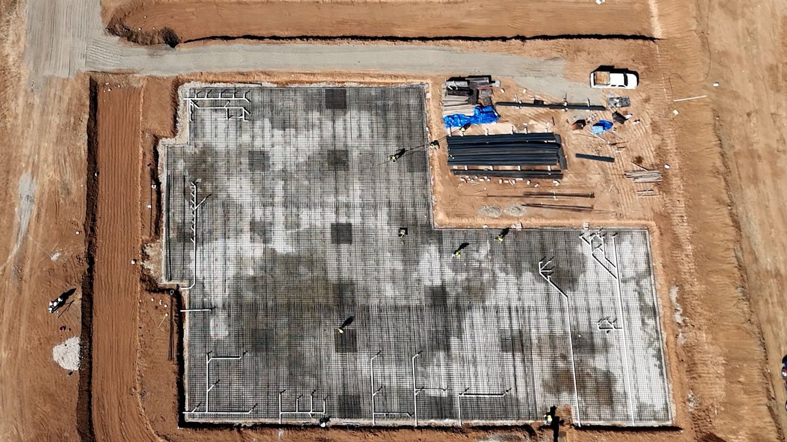 Overhead view of reinforcement, pipework and site materials