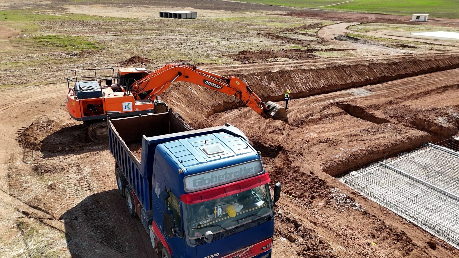 KATO earthmoving equipment working around a foundation excavation
