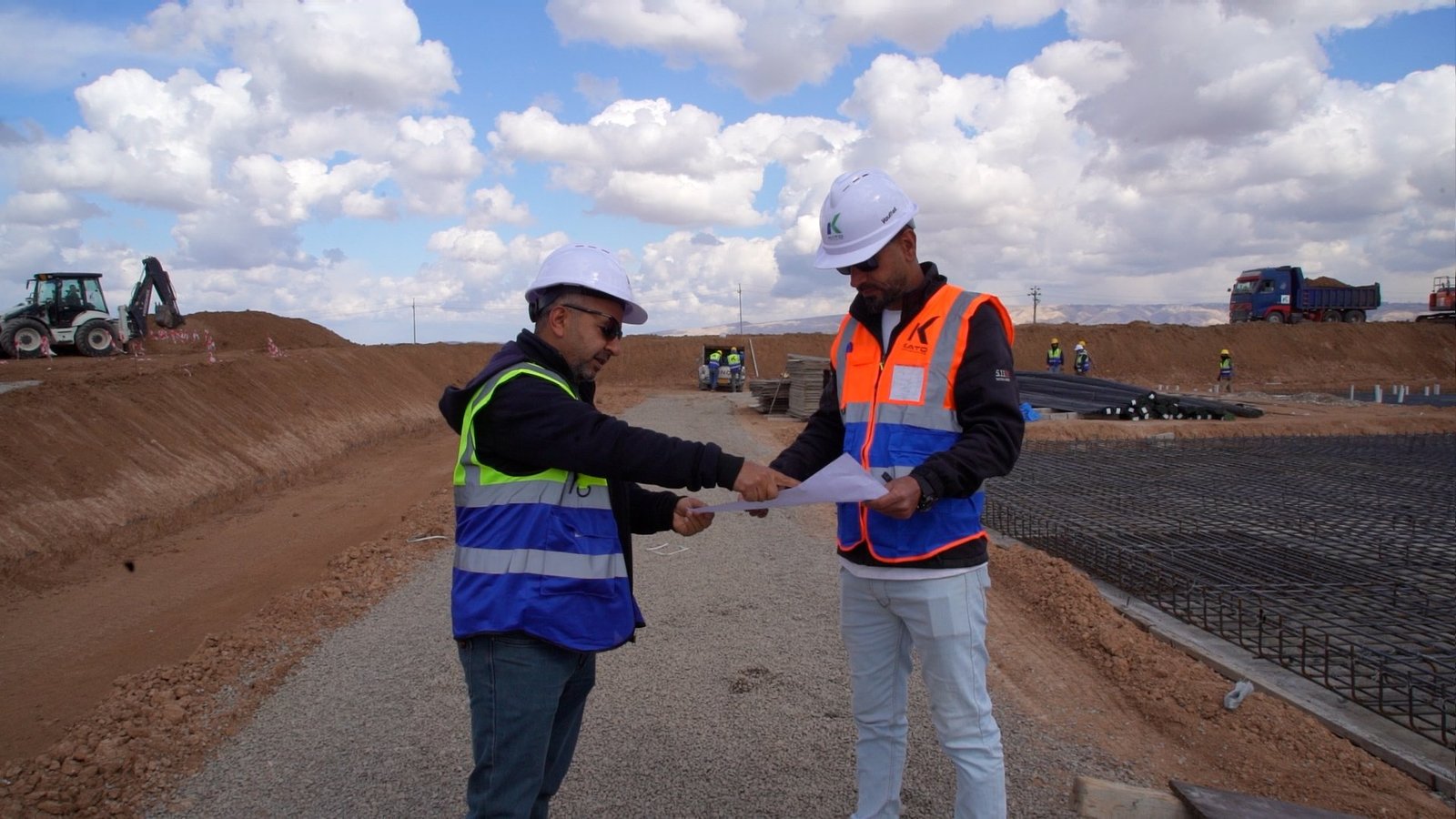 KATO team members reviewing drawings beside the construction works