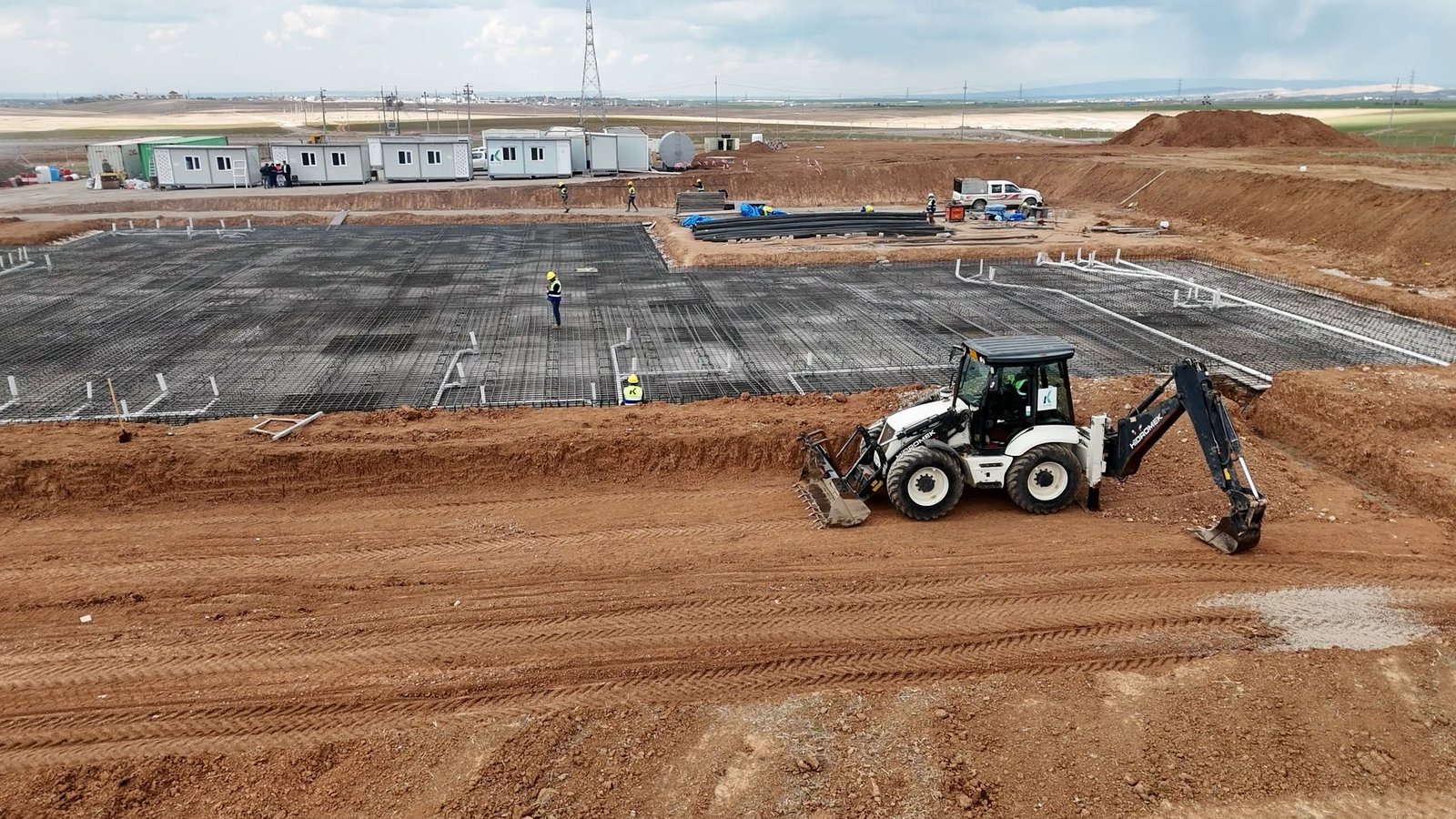 A foundation reinforcement area with KATO equipment and site facilities