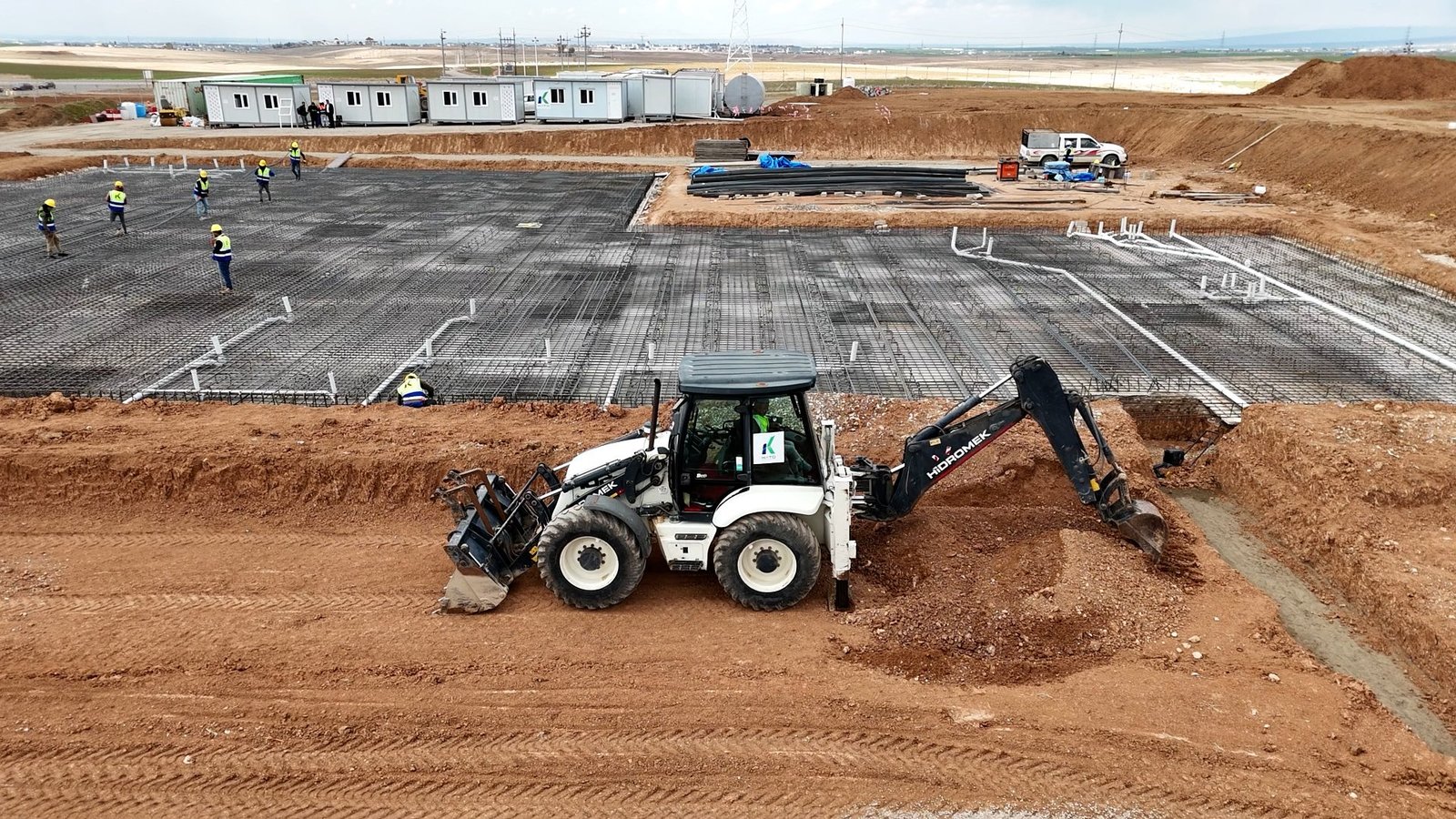 A KATO backhoe working alongside foundation reinforcement